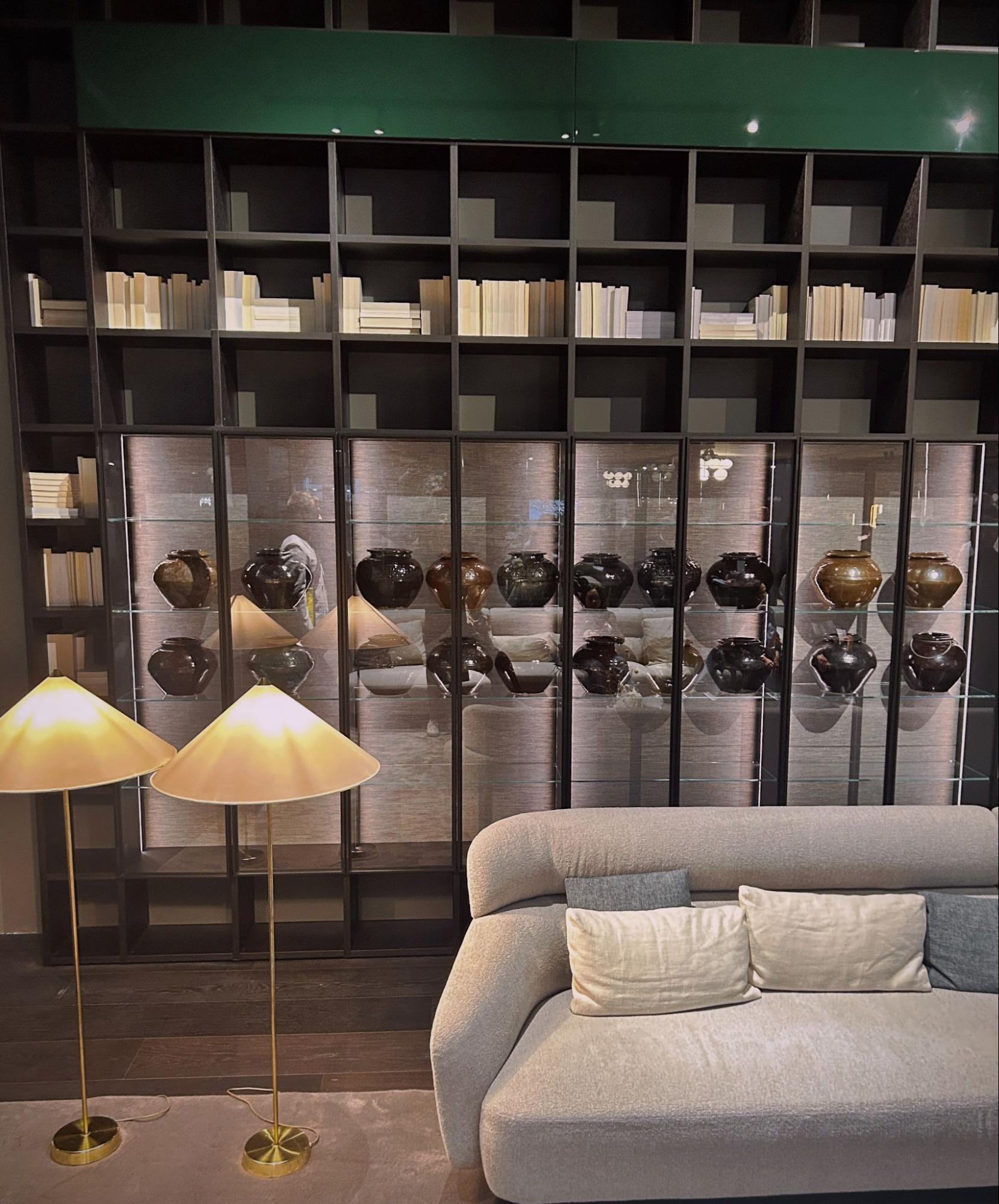 Rows of glazed Chinese pottery in the Lema Mobili library cabinet.
